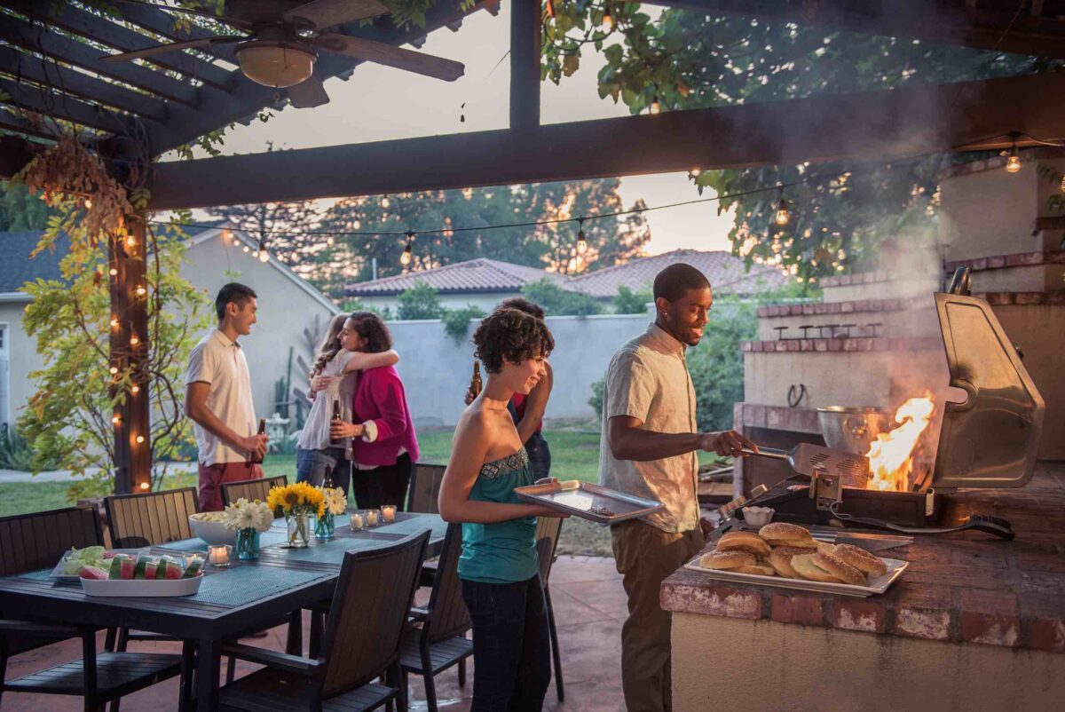 Family and friends enjoying their backyard with Smart Lighting for Outdoor Settings